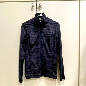 Under Armour full zip, mock neck jacket in a black and gray horizontals stripe.